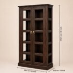 Dark walnut finish sheesham wood glass door bookcase with brass ring handles styled in a living room with books