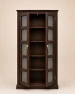 Dark walnut finish sheesham wood glass door bookcase with brass ring handles styled in a living room with books